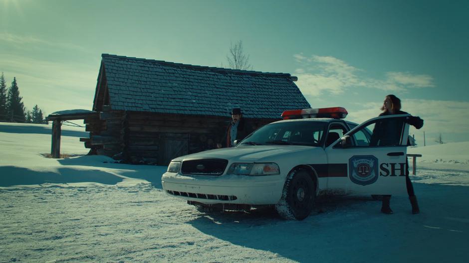 Doc and Nicole get out of Nicole's squad car.