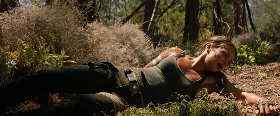 Lara struggles to sit up after falling from above.