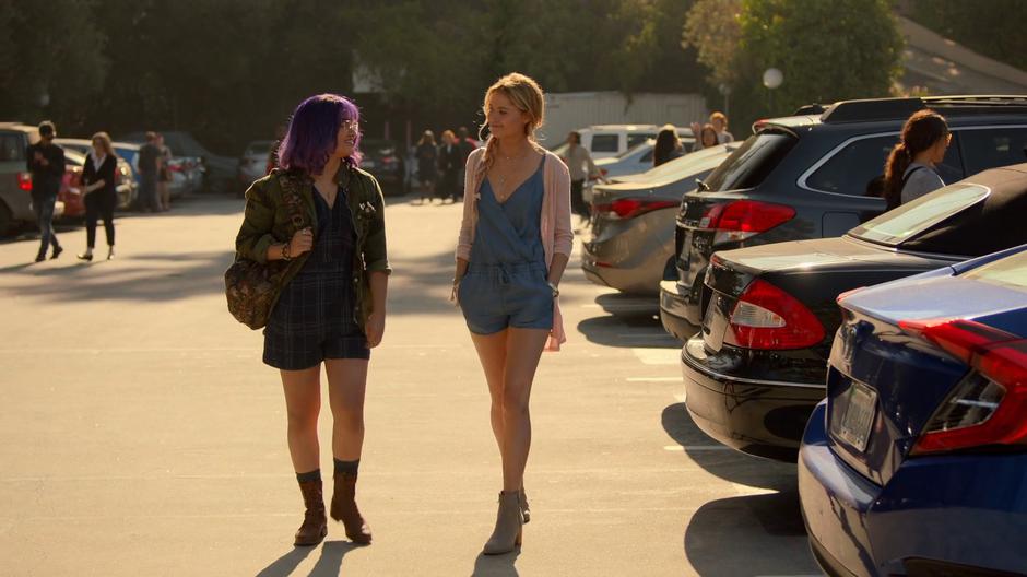 Gert talks with Karolina as they walk through the parking lot after school.