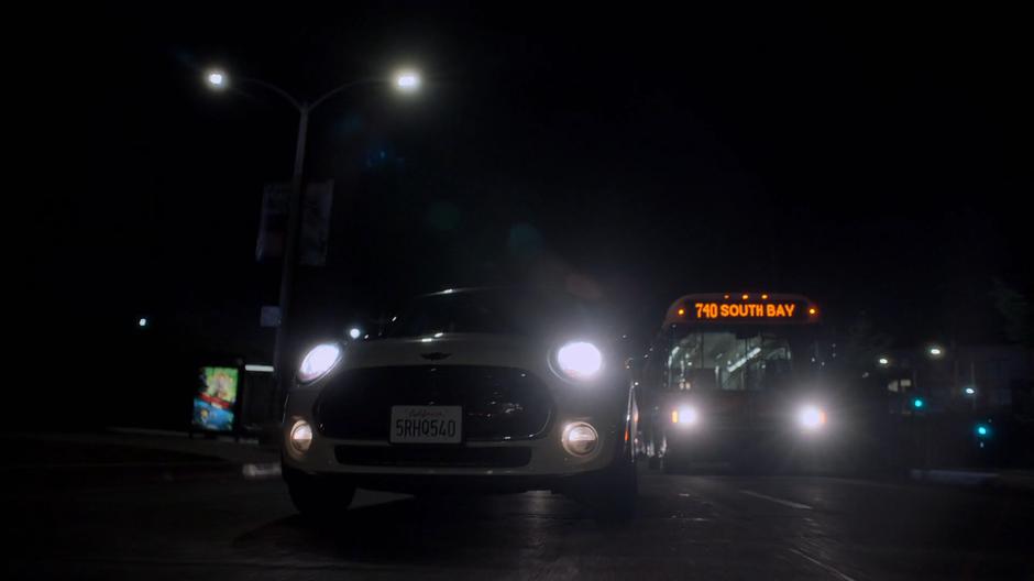 The kids drive past a bus while racing after Alex.