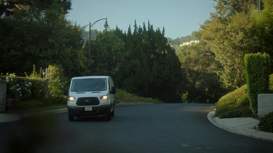 Victor drives his van down a quiet street.