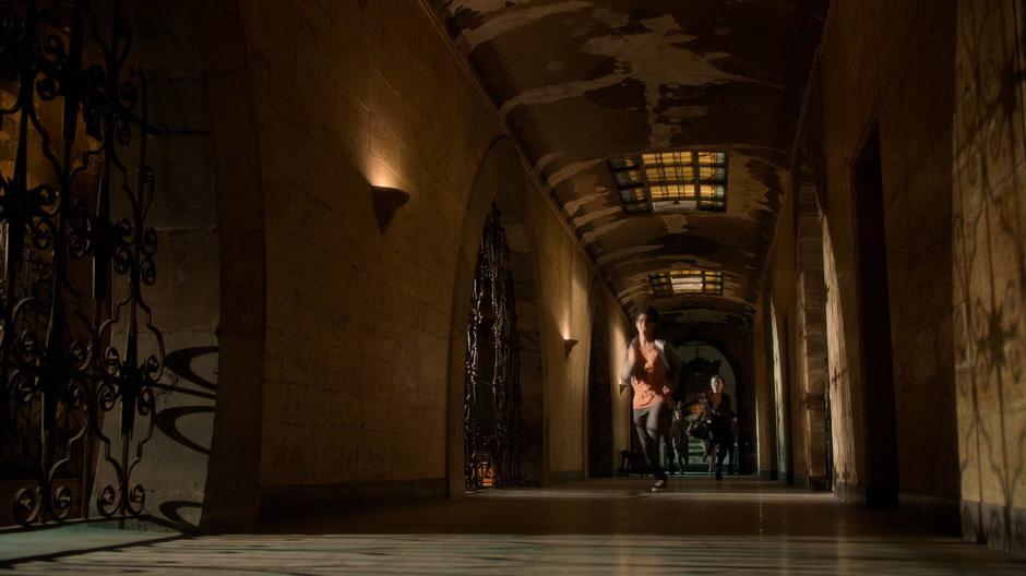 The kids run down the hallway leading back out of the temple.