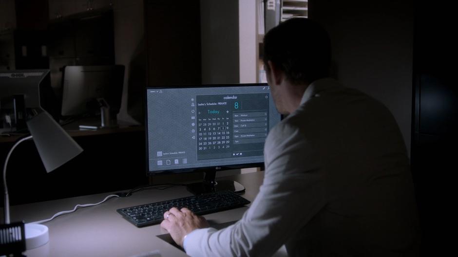 Frank examines his wife's calendar on the computer in the deserted offices.