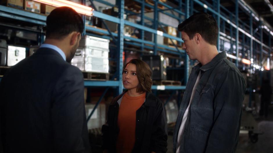 Barry watches Nora as she makes up a cover story to explain her presence to Captain Singh.