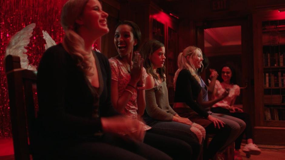 Maggie sits shocked in the middle of the other accepted pledges who all look excited.