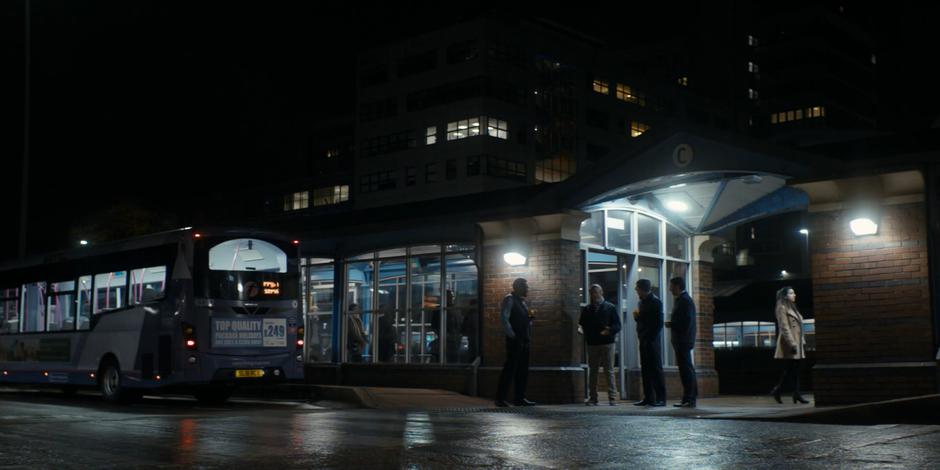 Graham talks to three of his old bus driver coworkers while they are on their break.