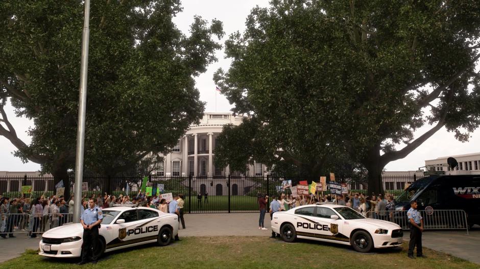 The two opposing sides of the protest shout from across from one another.