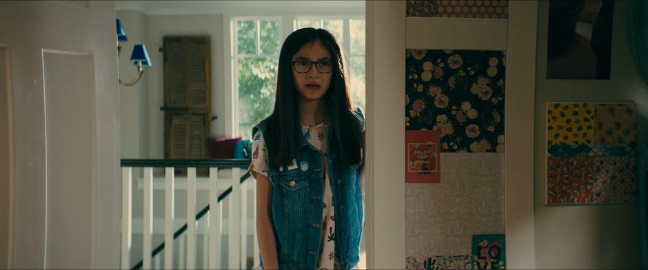 Kitty asks Lara Jean why she is looking out the window while standing in the doorway of Lara Jean's bedroom.