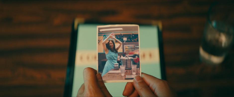 Lara Jean looks at a photo of her mother from the cafe years ago.