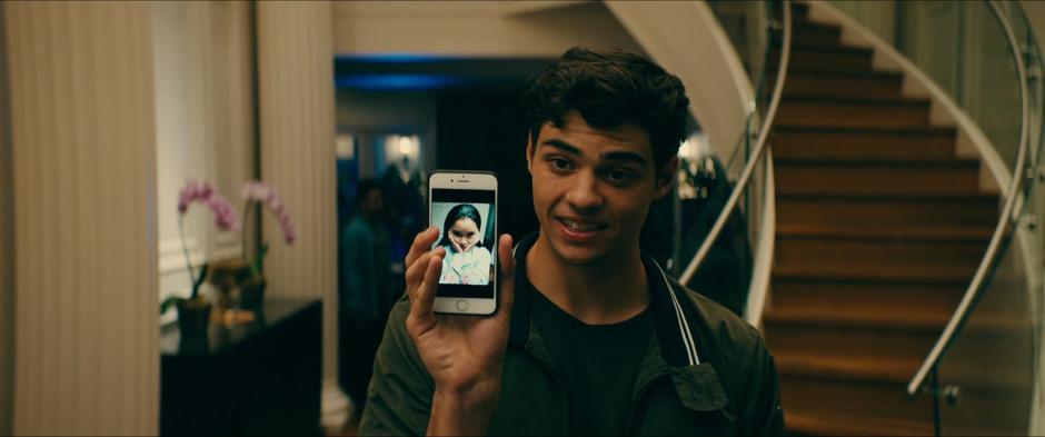 Peter shows Lara Jean the photo he just took of her looking cute.