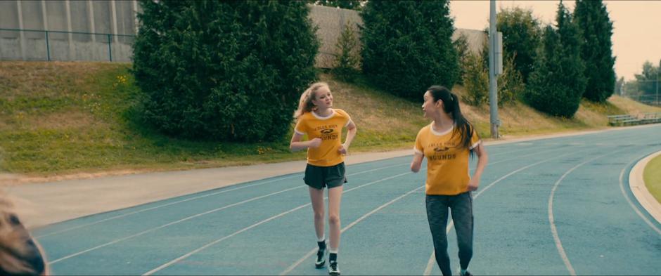 Chris and Lara Jean talk while running around the track.