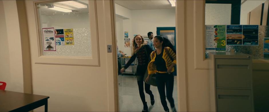 Lara Jean pulls Chris into an empty classroom to tell her about Peter.