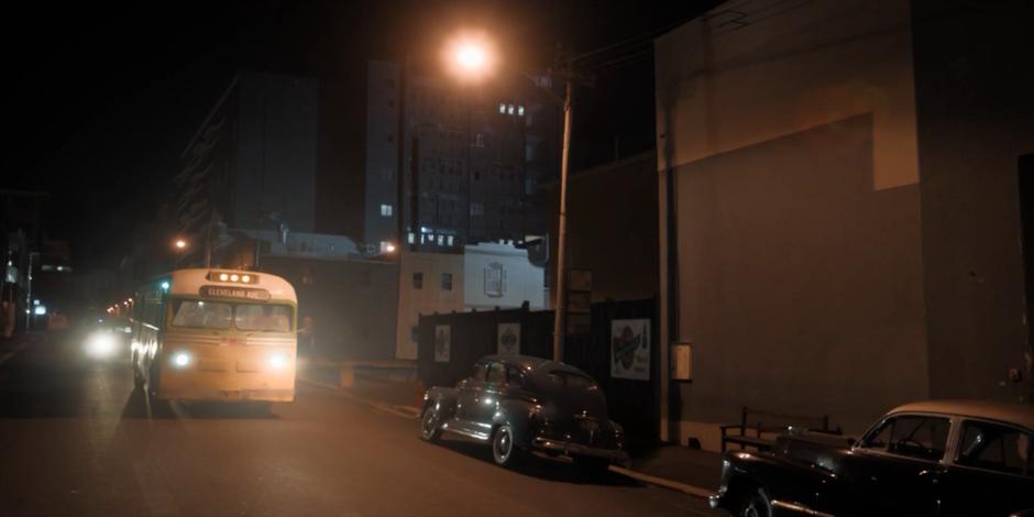 James Blake's bus drives down the street in the evening.