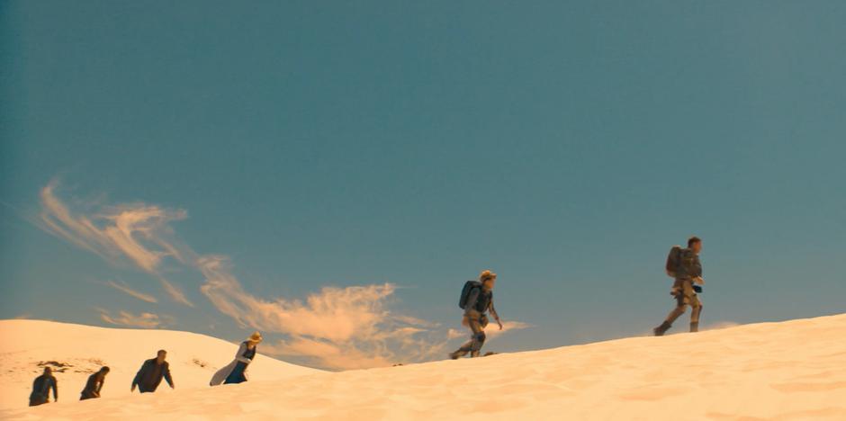 The Doctor and her friends follow Angstrom and Epzo across the sand dunes.