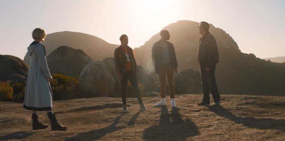 The Doctor, Yasmin, Ryan, and Graham look around the hilltop after the tent disappears from around them.