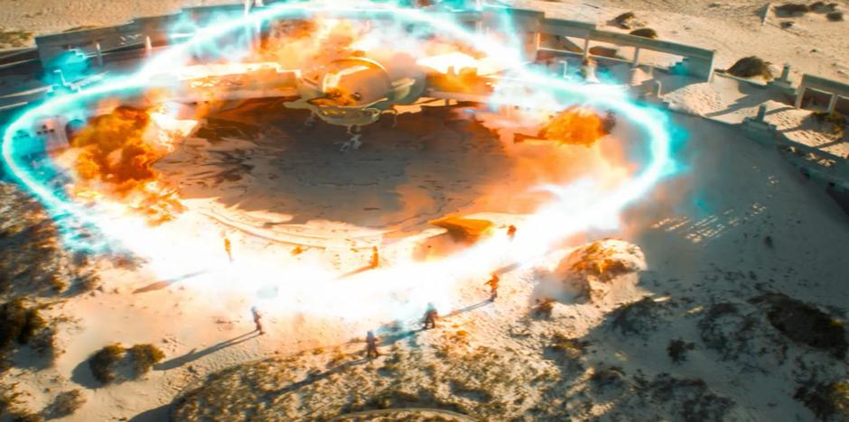 A large blast of energy bursts out from the ruins.