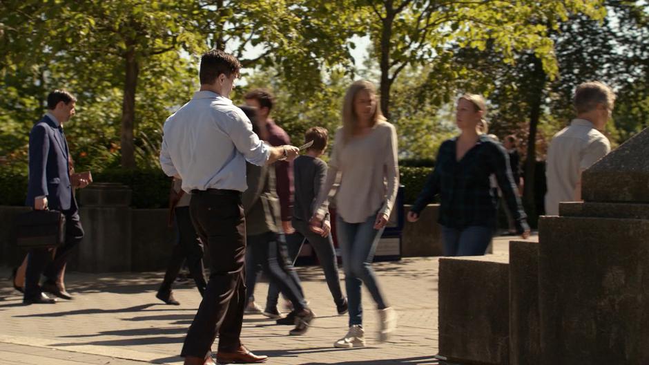 Ben Lockwood tries to hand out anti-alien fliers to people walking past.