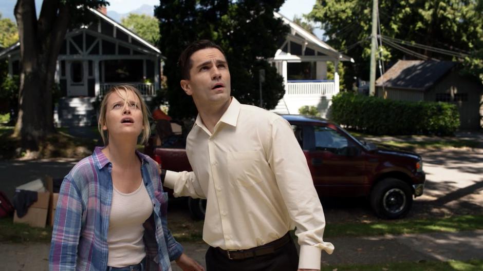 Lydia and Ben Lockwood look up at the alien battle in the skies above their home.