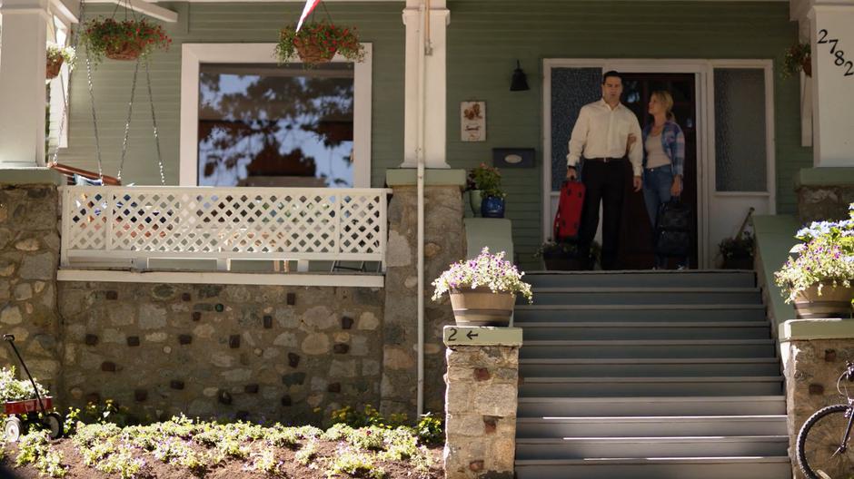 Lydia Lockwood talks to husband Ben on the porch of their home as they prepare to leave.