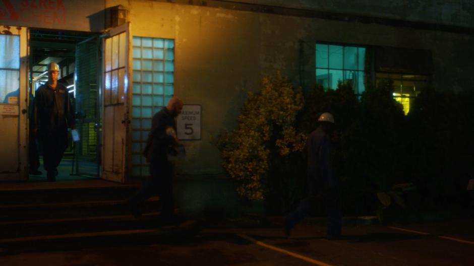 Workers exit the chemical plant at the end of their shift.
