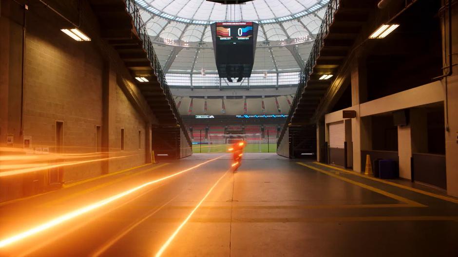 Barry runs into the stadium and onto the field.