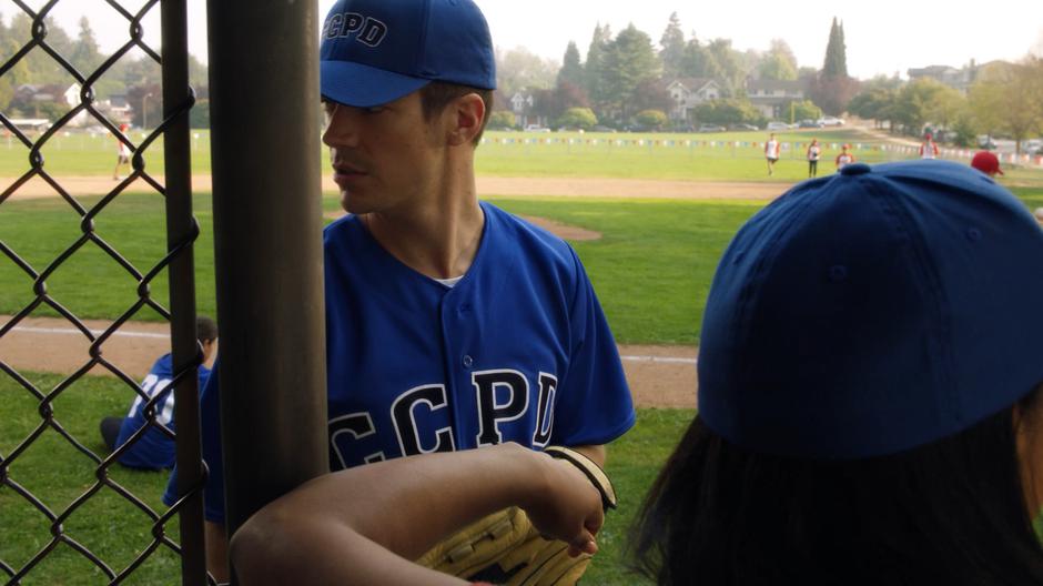 Barry looks around for the missing player Jones while standing with Iris before the game.