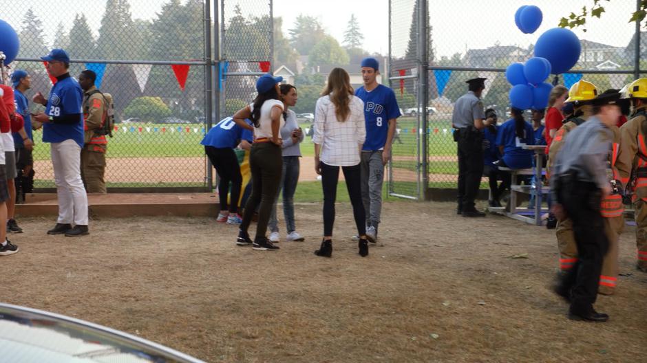 Iris, Nora, Caitlin, and Barry talk after the explosion as the police interview witnesses.