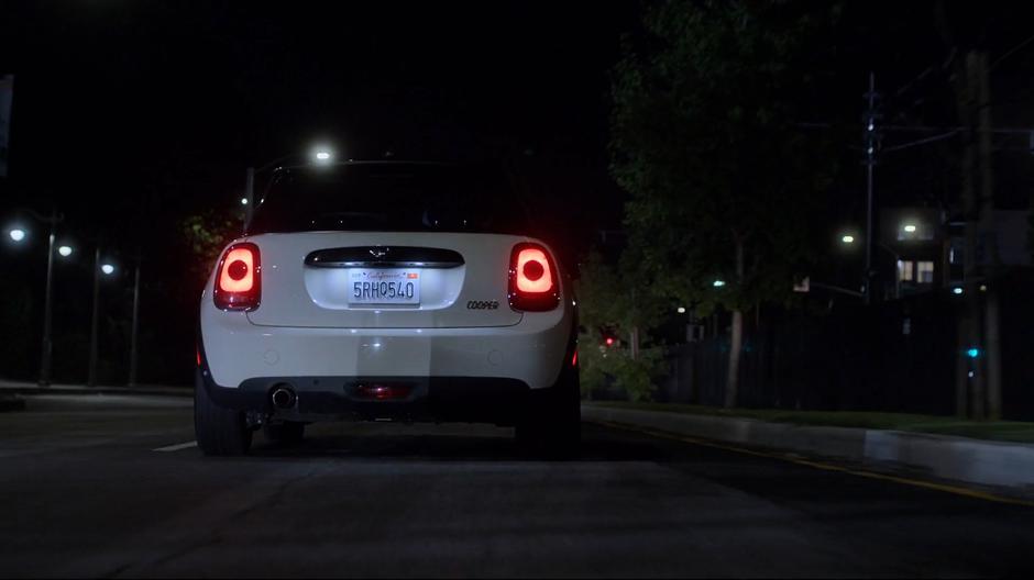 Karolina drives her car down the road following the light trail.