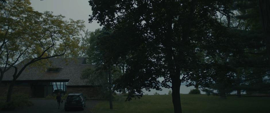 Louise walks from her car to the house after a day of school.