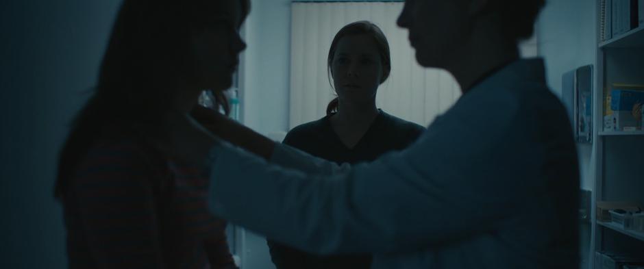 Louise watches as a doctor examines Hannah.