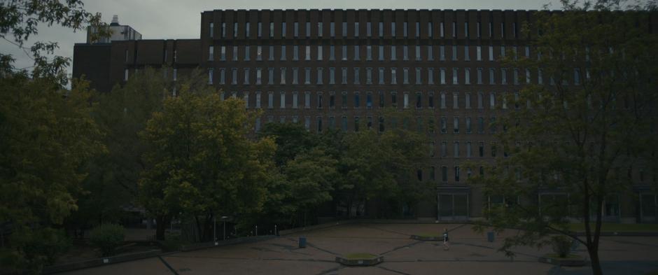 Louise walks across the empty plaza the day after the alien's arrival.