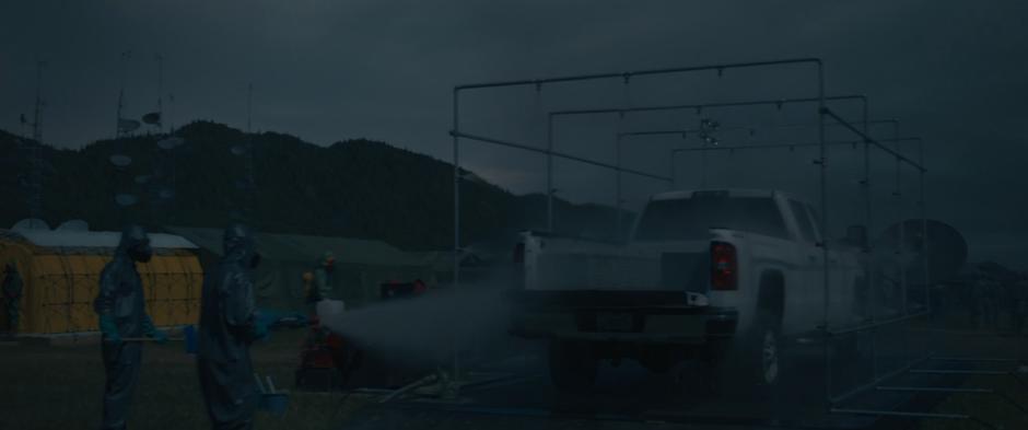 One of the pickup trucks that went to the alien craft is thoroughly cleaned upon arrival back at the camp.