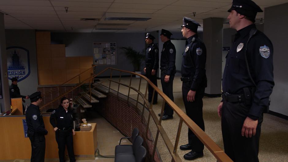 A police officer freaks out when she realizes she is surrounded by duplicates of the alien disguised as another officer.