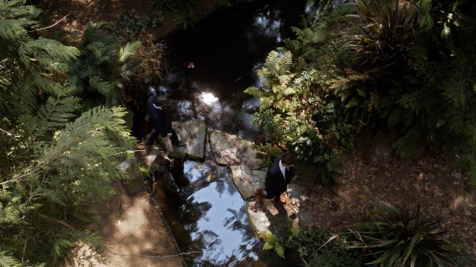 Gary and Nate cross a small stream on some stones.