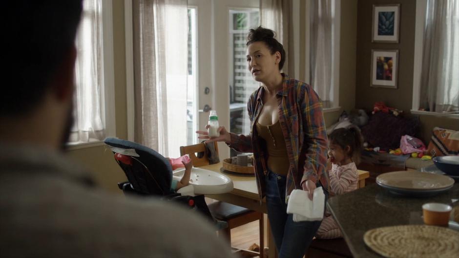 Carmen turns to talk to Dave as she prepares breakfast for her children.