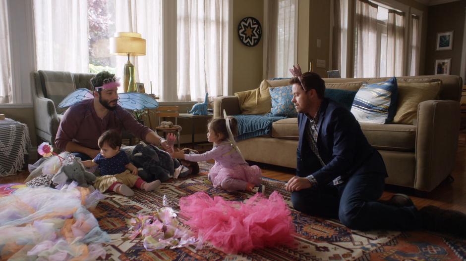 Dave and Jack play with Dave's kids on the living room floor.