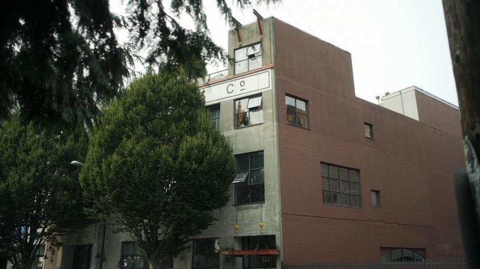 Establishing shot of the corner of the apartment building.