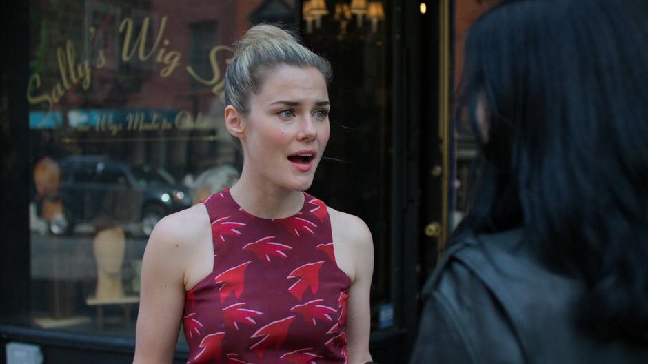 Trish stops to talk to Jessica outside the store.