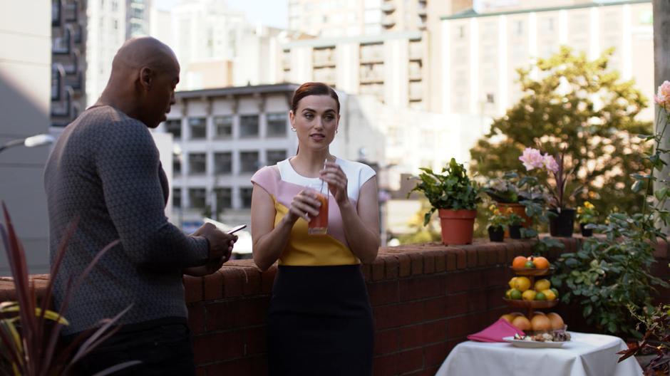 Lena tries to reassure James while they lean against the edge of the roof.