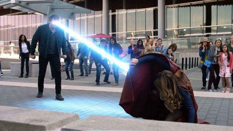 Jensen uses the laser vision he stole from Kara to shoot at her as she blocks with her cape.