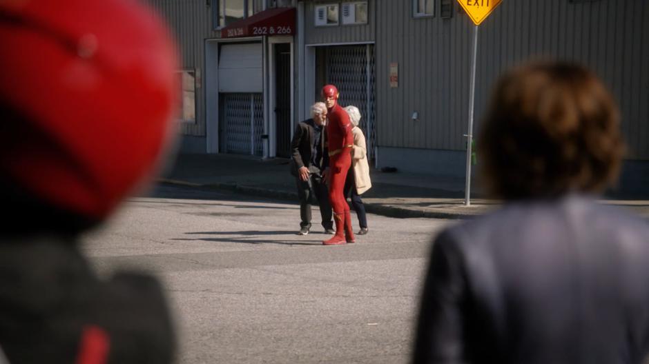 Barry glances back at Nora after rescuing the two bystanders.