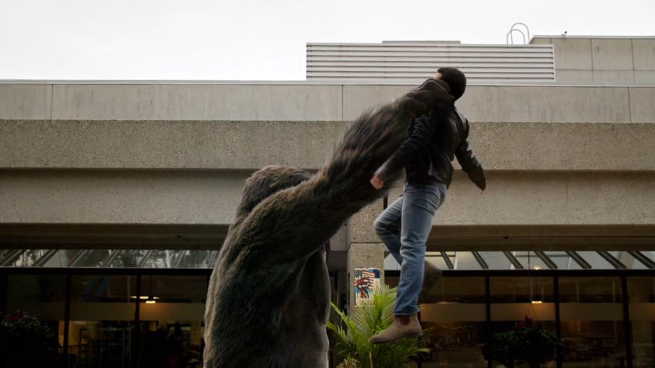 Grodd lifts Obama into the air by his throat.