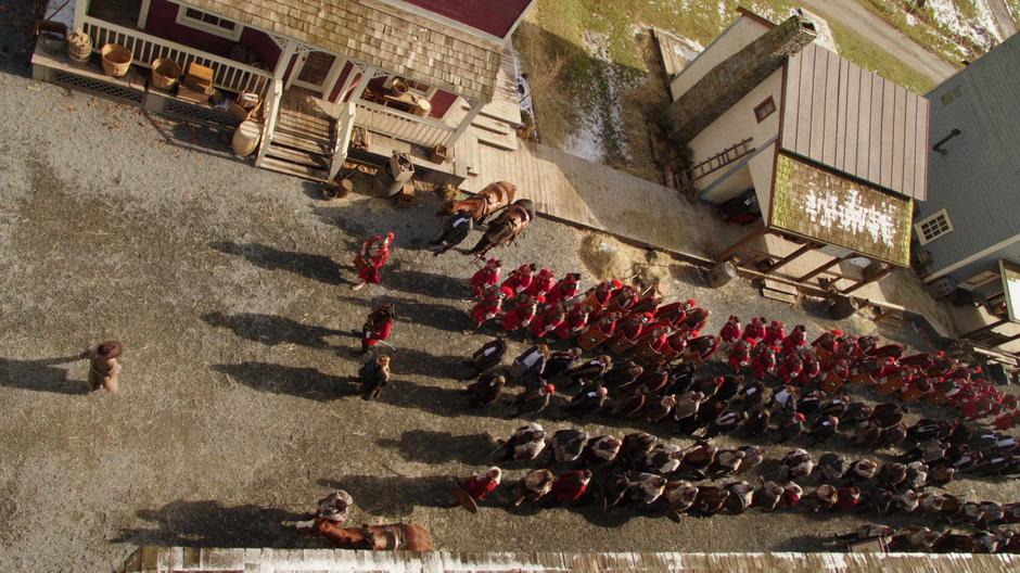 Sara stands in the street in front of the three armies led by Caesar, Blackbear, and Freydis.