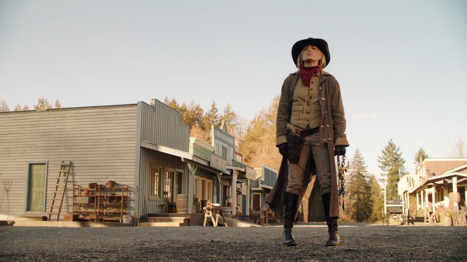 Sara stands in the middle of the street to stop the approaching armies.