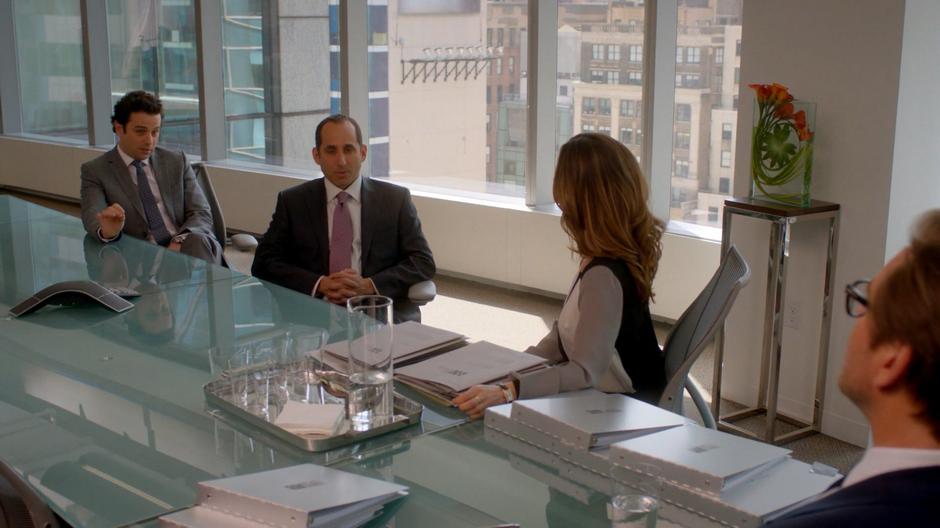 Harry Kemp and Garret Tilden sit at the conference room table talking to J.P. Nunnelly and Bull.