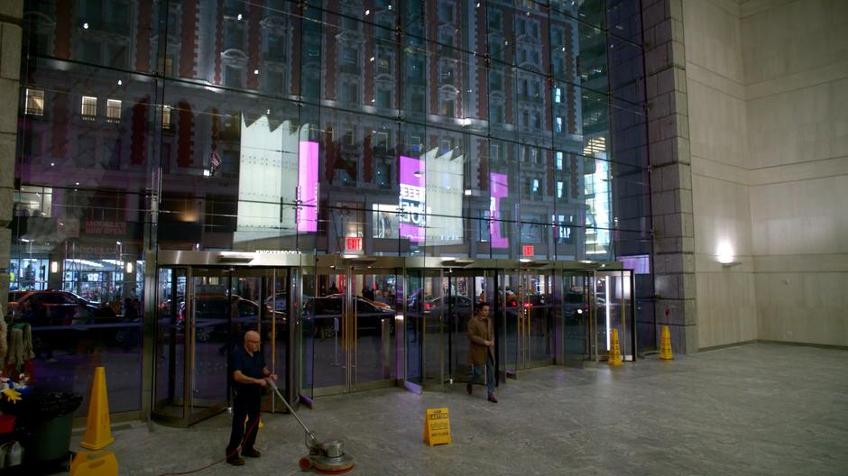 Harry Kemp walks into the lobby through the revolving doors.