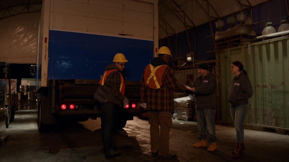 Baron and Suki talk to the two workers behind their truck.