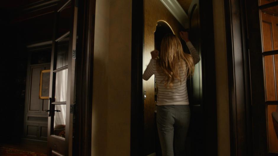Ava raises her hands in frustration as Nate uses his Time Courier to leave from the bathroom.
