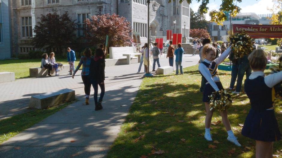 Maggie and Mel walk through the very 80s campus looking for Brenda.