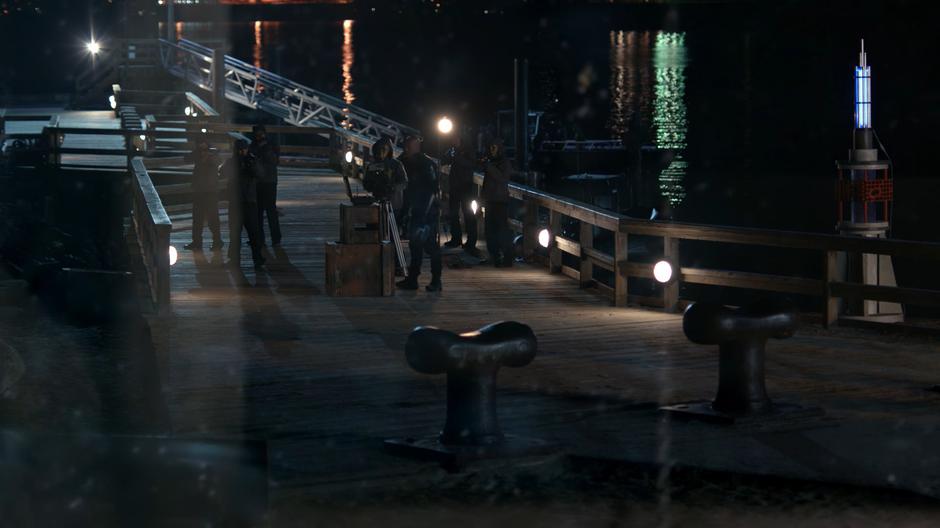 James is visible through the monument window on the dock in front of the detonator.